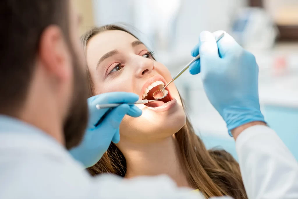Dentist examine patient teeth.