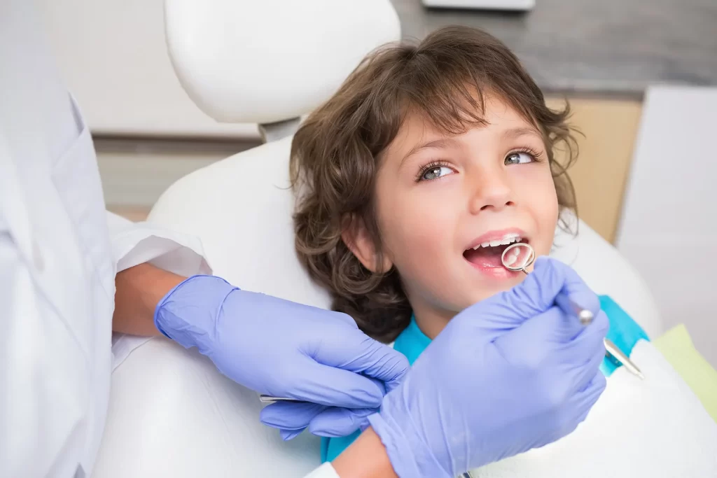 Little boy getting dental examination.