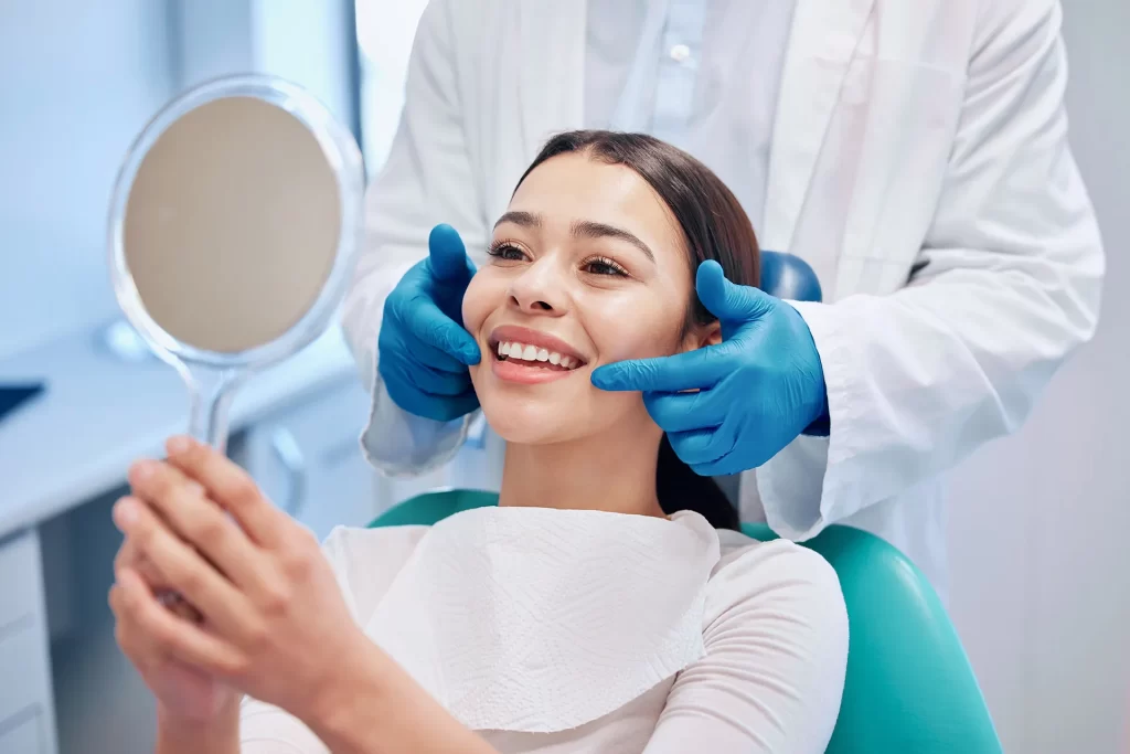 Woman check mirror after dental procedure