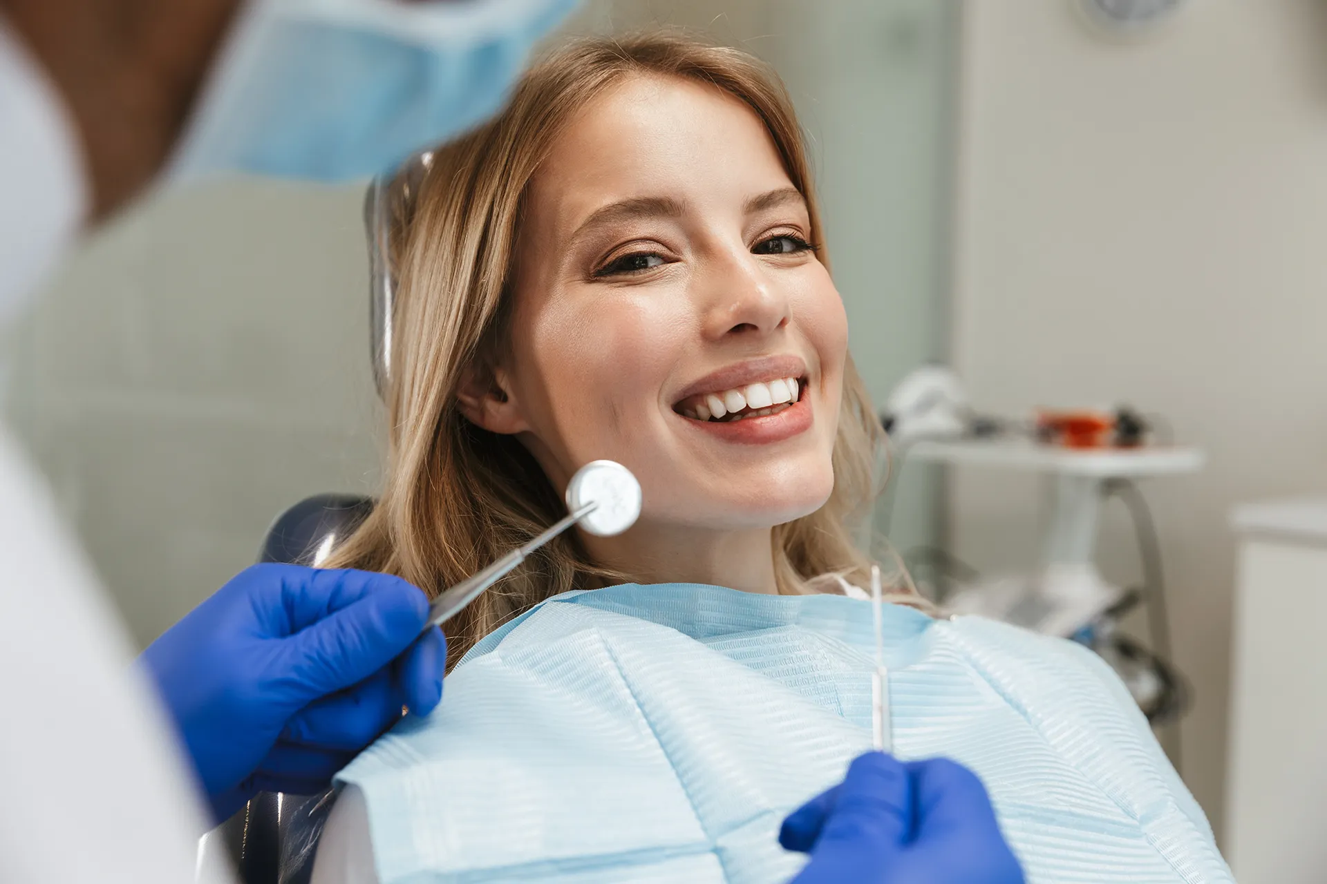 Woman sitting in dental chair getting procedure.