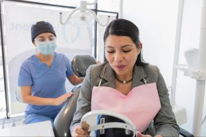 A dental assistant helping a patient.