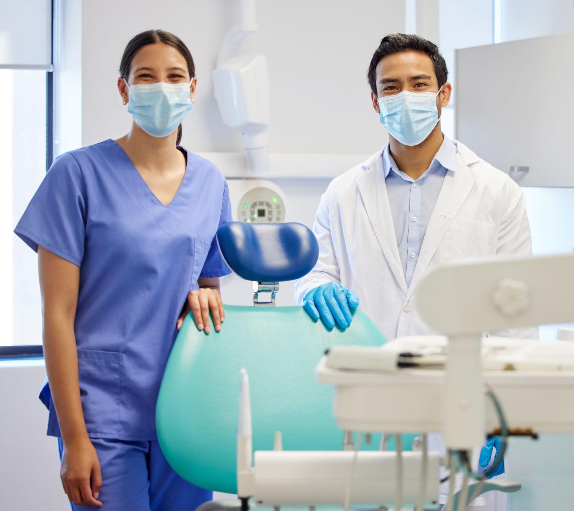 Portrait of a young dentist and assistant collaborating in a modern dental consulting room.