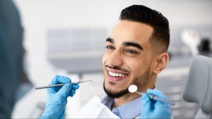 Man smiling in a dental exam chair.