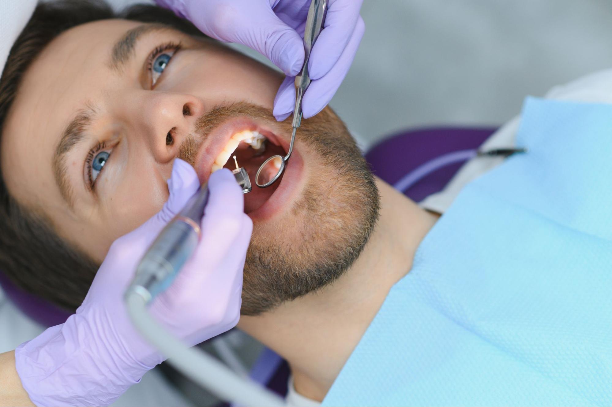 A close-up of a man undergoing a dental procedure.