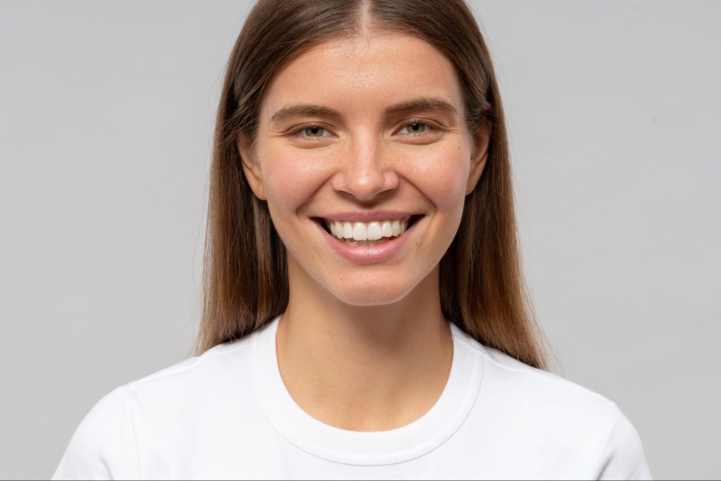 Woman with a straight, white smile.