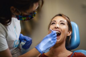 A happy patient receiving a smile makeover from a cosmetic dentist.