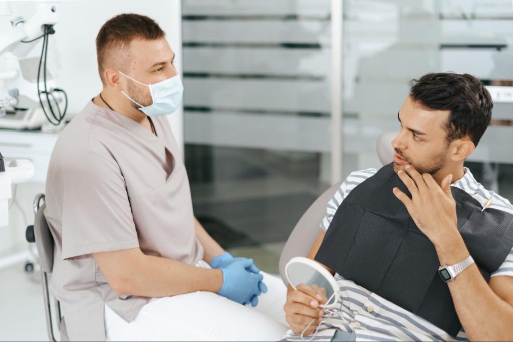 Dentist discussing wisdom teeth removal options with patient.